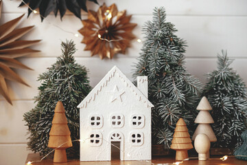 Merry Christmas! Christmas little house, trees, lights, paper stars. Magic winter village scene.