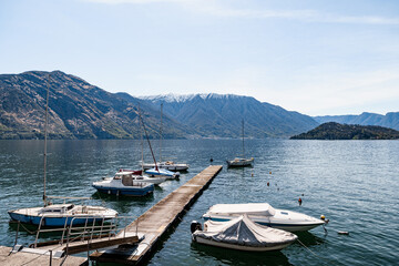 Long pier on Lake Como with moored yachts. Italy