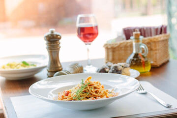 Spaghetti pasta with tomatoes and shrimps in a restaurant of italian food