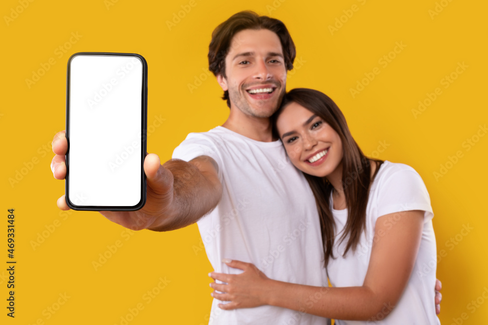 Poster couple showing white blank empty smartphone screen for mockup