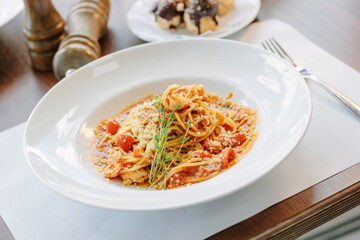 Spaghetti pasta with tomatoes and shrimps in a restaurant of italian food