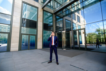 A man business man talking on the phone on the street