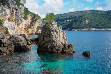 Fototapeta na wymiar beautiful bay with rocky beach La Grotta in Paleokastritsa, Corfu island, Greece