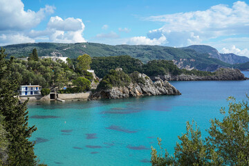 turquoise sea and cliff coastline of touristic town Paleokastritsa, Corfu island, Greece