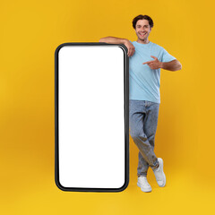 Man pointing at big white empty smartphone screen, mockup