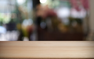 Empty wooden table in front of abstract blurred background of coffee shop . can be used for display or montage your products.Mock up for display of product