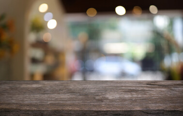 Empty wooden table in front of abstract blurred background of coffee shop . can be used for display or montage your products.Mock up for display of product