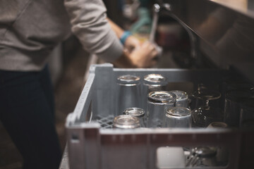 Fototapeta na wymiar a person washing dishes in a bar