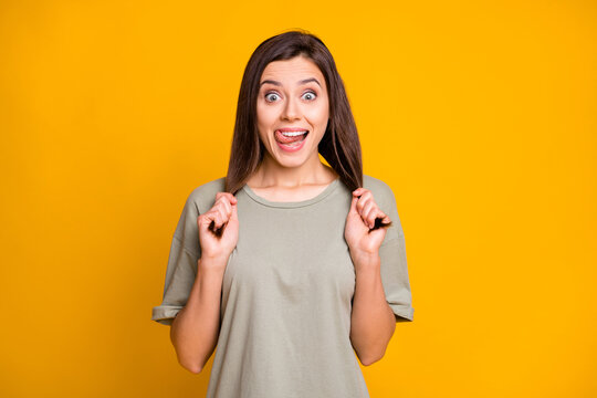 Photo of young happy excited crazy smiling cheerful positive girl pull hair stick tongue out isolated on yellow color background