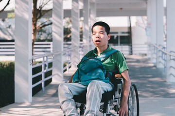 sian special child on wheelchair is smiling face as happiness on ramp for disabled people background in hospital, Lifestyle in the education age of disabled children, Happy disability kid concept.