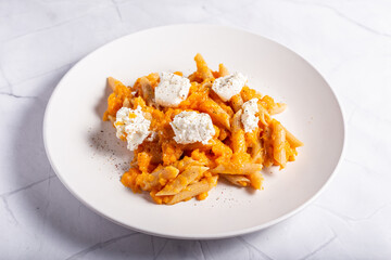 Pasta with pumpkin and goat cheese. Autumnal pasta with pumpkin.