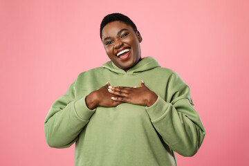 Black Woman Pressing Hands To Chest Expressing Gratitude, Pink Background