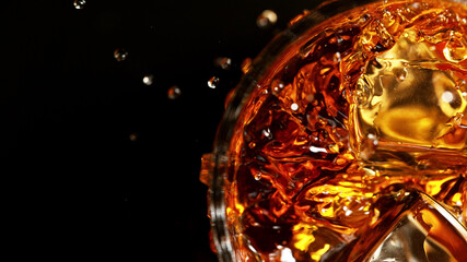 Top shot of whisky glass with ice cubes, closeup.