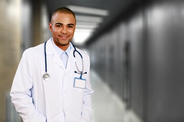 Smiling doctor wearing medical coat looking at camera.