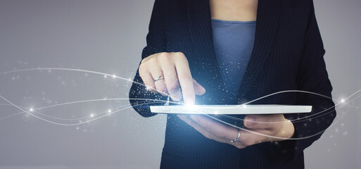 Business network communication and innovation technology concept. White tablet in businesswoman hand with digital hologram wave icon. Background big data visualization futuristic technology.