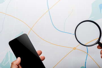 Closeup photo of private detective with smartphone and magnifier searching evidences