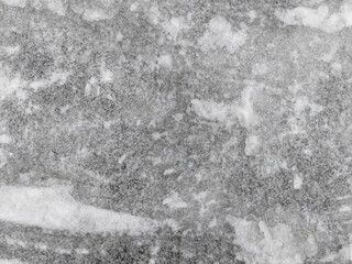 Closeup photo of slick frozen winter road after snow