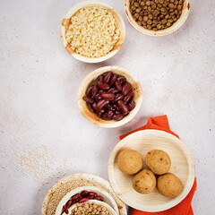 Vegan food background, cooked quinoa, lentils, red beans, Vegetarian Meatballs in Palm Leaf Plates. Healthy food macrobiotic diet.