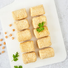 Raw vegetarian gluten free croquettes made with chickpeas. A nutritious vegan starter. Meat alternative Vegetarian Food delivery concept.