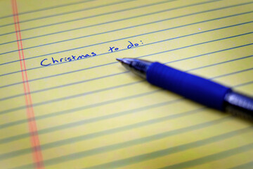 Christmas To Do List on Notebook Paper and Pen