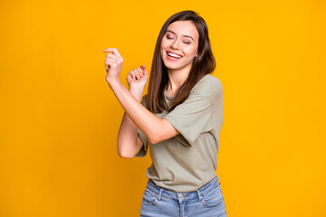 Photo of young attractive lovely smiling cheerful positive dreamy girl dancing isolated on yellow color background