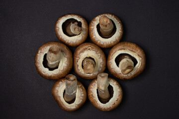 Brown champignons on a black background. Champignon variety. Healthy vegetarian food.