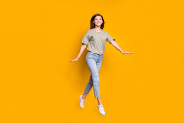 Fototapeta na wymiar Full size photo of young happy smiling positive cheerful pretty girl jumping isolated on yellow color background