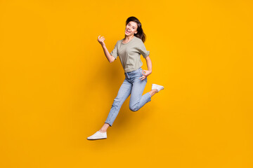 Fototapeta na wymiar Full size photo of young beautiful funky happy smiling girl jump play invisible guitar isolated on yellow color background