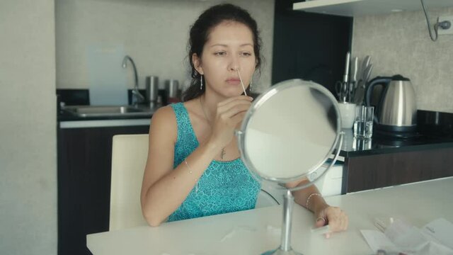 Young woman performs a Covid-19 antigen self-test