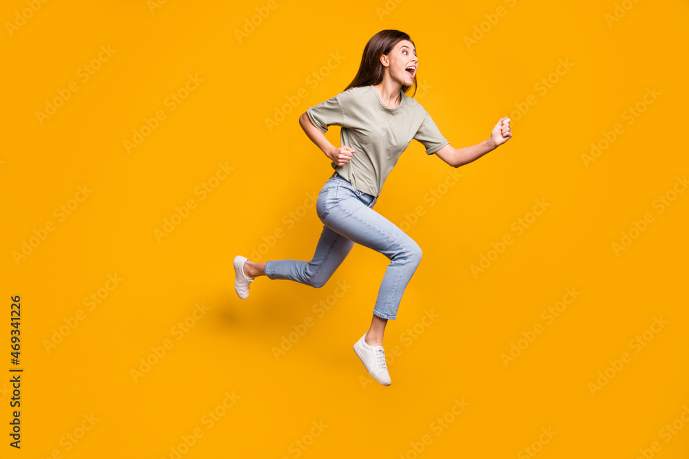 Sticker full length body size view of lovely motivated cheerful girl jumping running isolated over bright ye