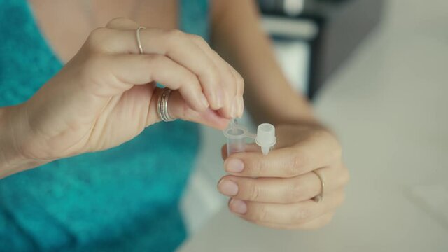 Young woman performs a Covid-19 antigen self-test