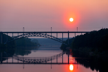 Fototapeta premium railway bridge over the river, summer evening and sunset sky