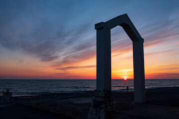 skyline on the sea during sunset, beautiful sky, blurred clouds and the sea. sea view through the arch