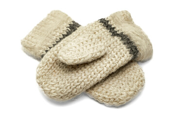Knitted warm woolen mittens on a white background