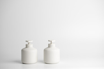 White minimalistic ceramic dispensers with pump for sanitiser and soap. COVID-19 Coronavirus concept. Virus prevention, personal hygiene routines