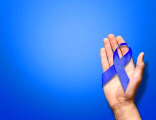 November. Blue ribbon in hands. Awareness prostate cancer of men health