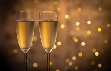 Champagne glasses over holiday bokeh blinking background, glasses with sparkling wine, celebration, party