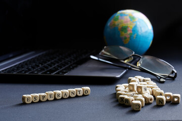 Esperanto inscription next to an open laptop, glasses and globe. The concept of modern technologies...
