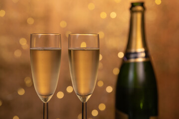 Champagne glasses over holiday bokeh blinking background, glasses with sparkling wine, celebration, party