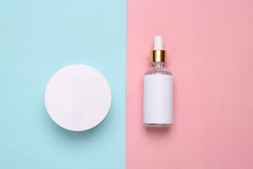 mockup serum bottle, cream jar on pink blue background. Creative trendy beauty flat lay