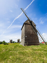 Moraczewo, Poland - August 09, 2021. Wooden windmills in Summer on the green meadow