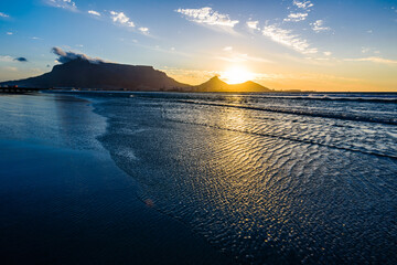 A beautiful sunset over the Table mountain in South Africa from the Lagoon beach. 