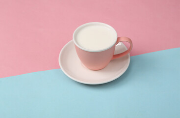 Obraz na płótnie Canvas Milk cup on blue pink background