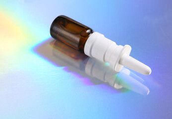 Nasal spray on colored reflective holographic surface