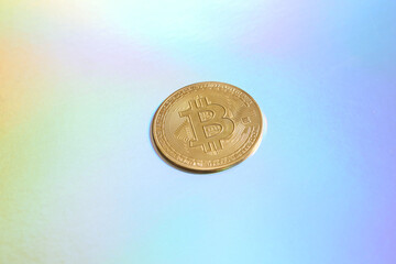 Bitcoin on colored reflective holographic surface
