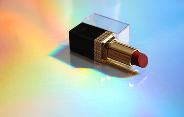 Lipstick on colored reflective holographic surface