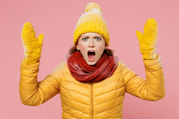 Displeased irritated dissatisfied young woman 20s years old wears yellow jacket hat mittens look...