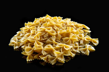 Pasta. Italian food. Bow-shaped pasta. Isolate on a black background. Photo