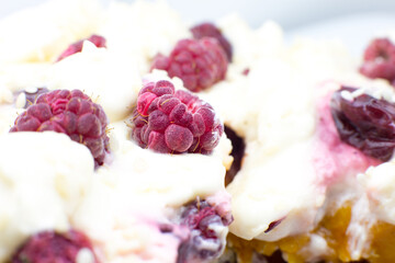 Tasty homemade cake with cream, fresh cherries and raspberry.