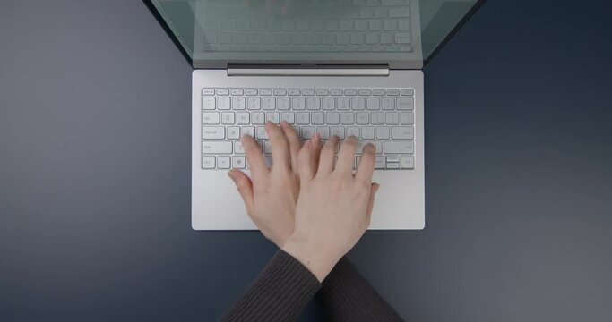 Flat home office desk. Workspace concept. Minimalist workspace with laptop, tablet and woman typing on keyboard, top view. Working on the computer